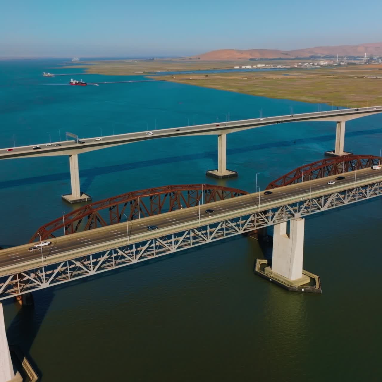 Lively traffic by the bridges connecting Martinez to Benicia. Beautiful scenery of the bay California, USA on clear bright sunny day