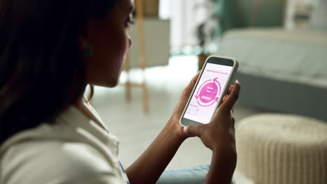 woman using a period tracker app on her phone