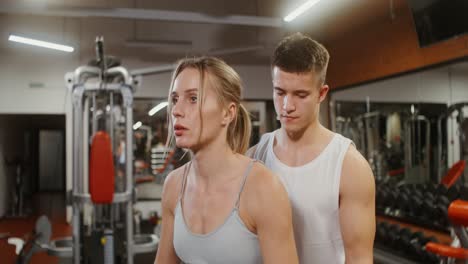 woman and trainer workout in gym