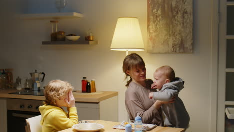 happy mom enjoying time with two little sons at home