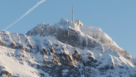 Drone-perspective-revealing-the-silhouette-of-a-snowy-mountain-range-at-dawn