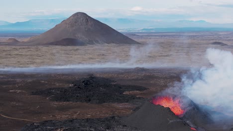 volcano cones in iceland with active crater spewing magma