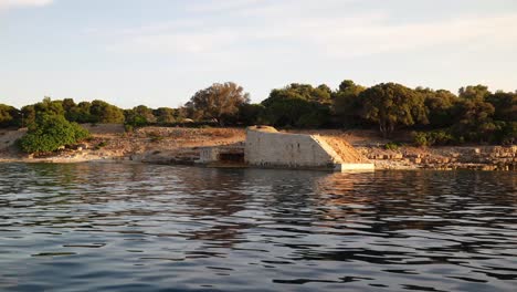 Stone-foundations-on-coastline-and-landscape-background