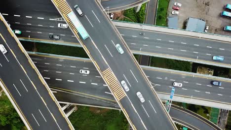 aerial cenital shot of circular roads and highways floating five levels exchange in chongqing and cars driving on them, huangjuewan exchange