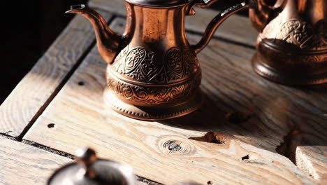 copper teapots on a wooden table