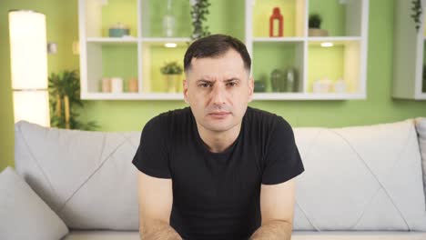 portrait of a man suffering from blurred vision, severe eye pain, headache.