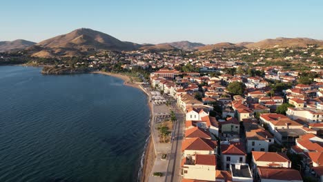 romeikos gialos street, beach pedestrian road in limnos island greece, aerial dolly, afternoon lighting