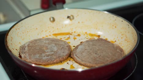 Two-Beef-Patties-Cooking-in-Red-Pan