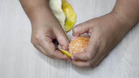 sequential peeling of an orange by hands