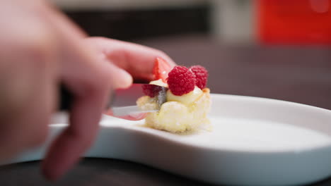 woman cuts half pastry at table for diet controlled snack