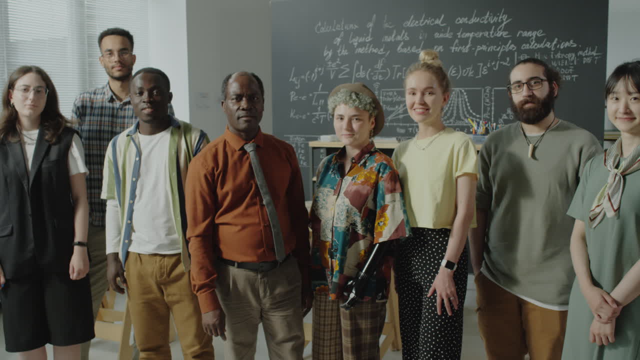 Diverse group of academics standing in front of a blackboard in a classroom