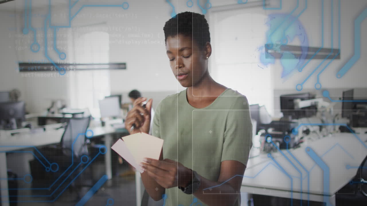 Animation of data processing over african american businesswoman in office