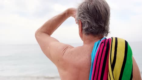 retired man looking away on the beach