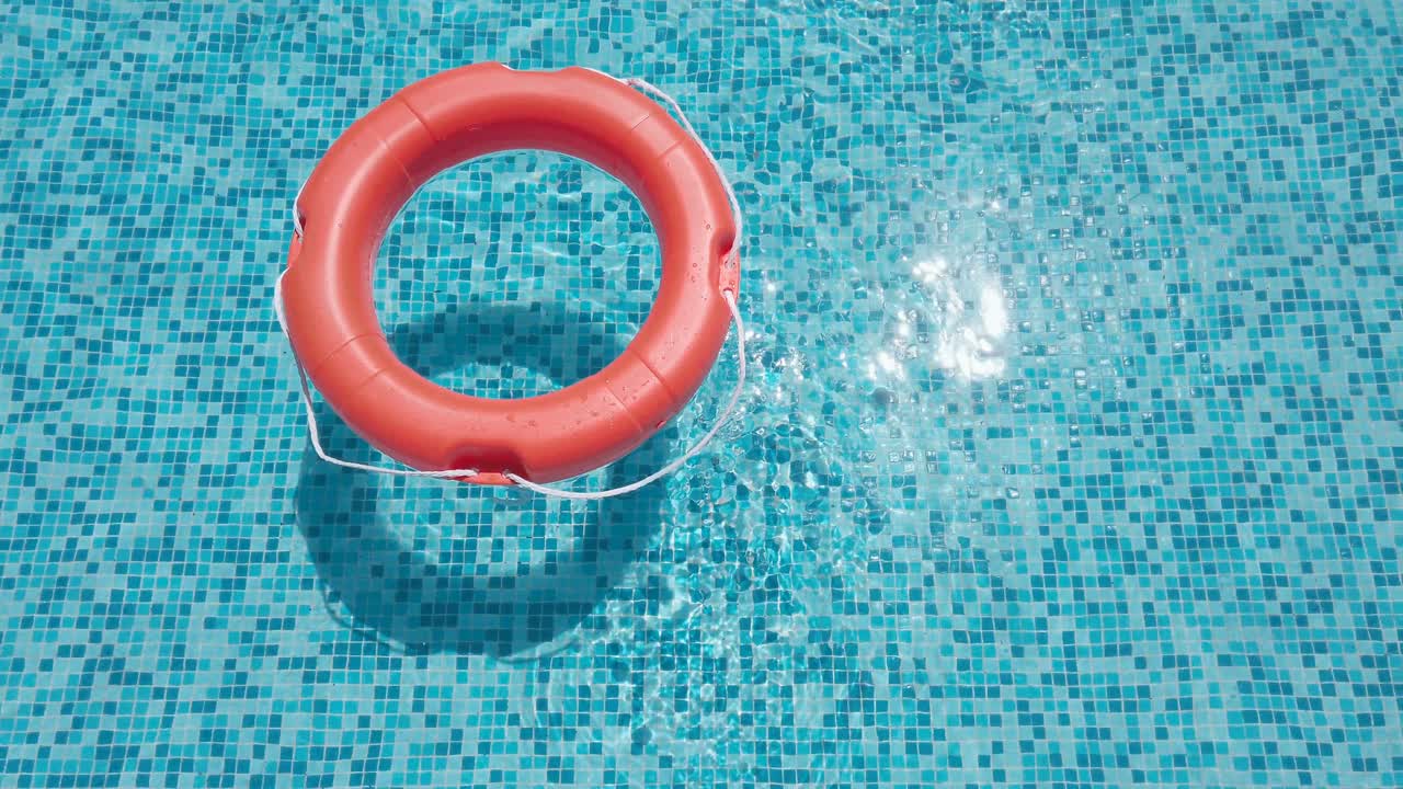 Orange Safety Lifebelt In Swimming Pool Closeup
