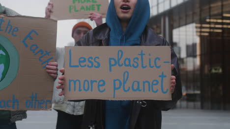 group of young activists with banners protesting against climate change to save the earth 1