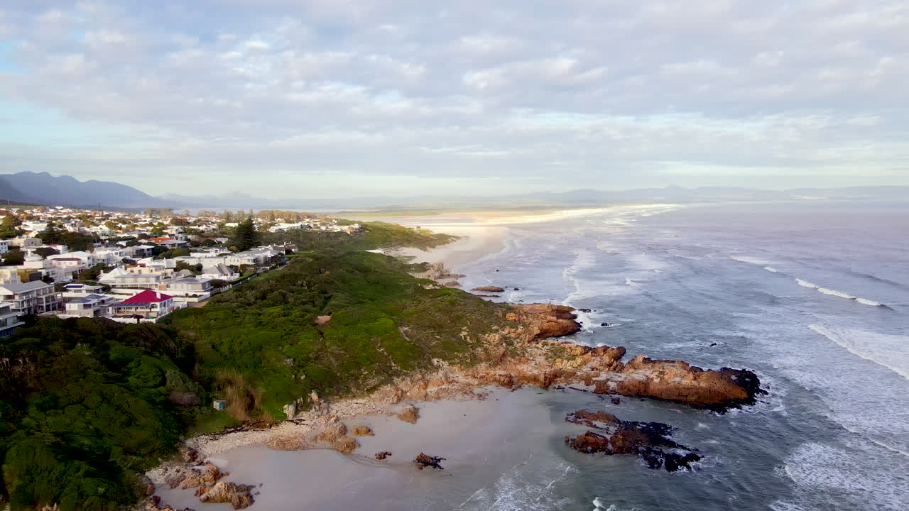 Scenic Hermanus coastline with sandy coves and beaches along rocky shore. Aerial
