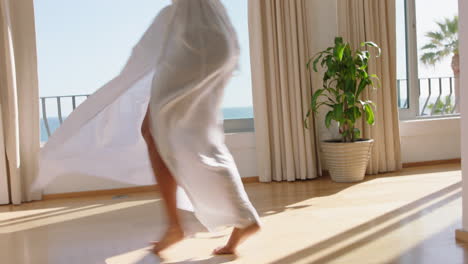 travel woman dancing in hotel room having fun celebrating summer vacation enjoying carefree holiday lifestyle