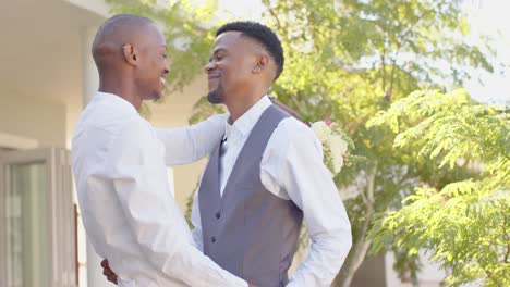happy african american gay male couple dancing together at wedding, slow motion