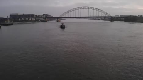 Aerial-dolly-shot-of-container-ship-on-the-river-Noord-in-early-morning