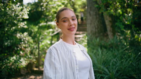 romantic model walking green park close up. happy woman strolling sunny forest