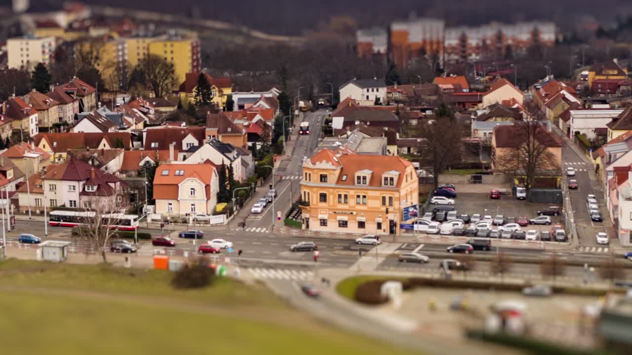 Aerial view of the Divoka Sarka tram stop and Liboc neighborhood in  Prague, Chehia. Usual traffic on the Evropska avenue, cars, busses and trams. Hvezda park is seen in a distance.