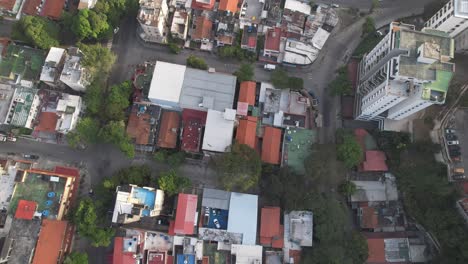 A colorful urban neighborhood with streets, buildings, and trees, aerial view