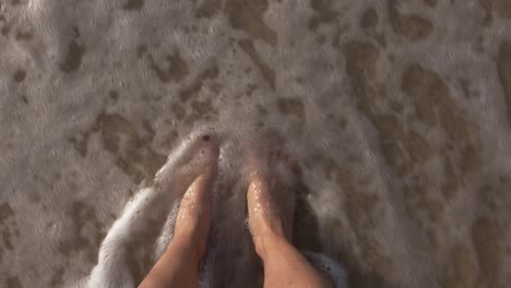 woman letting the waves kiss her feet