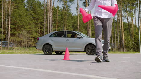 man placing traffic cones