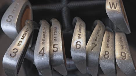 static shot of a full set of used golf irons and wedges within a golf bag