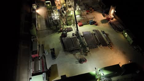 gas drilling station with night lights - aerial top