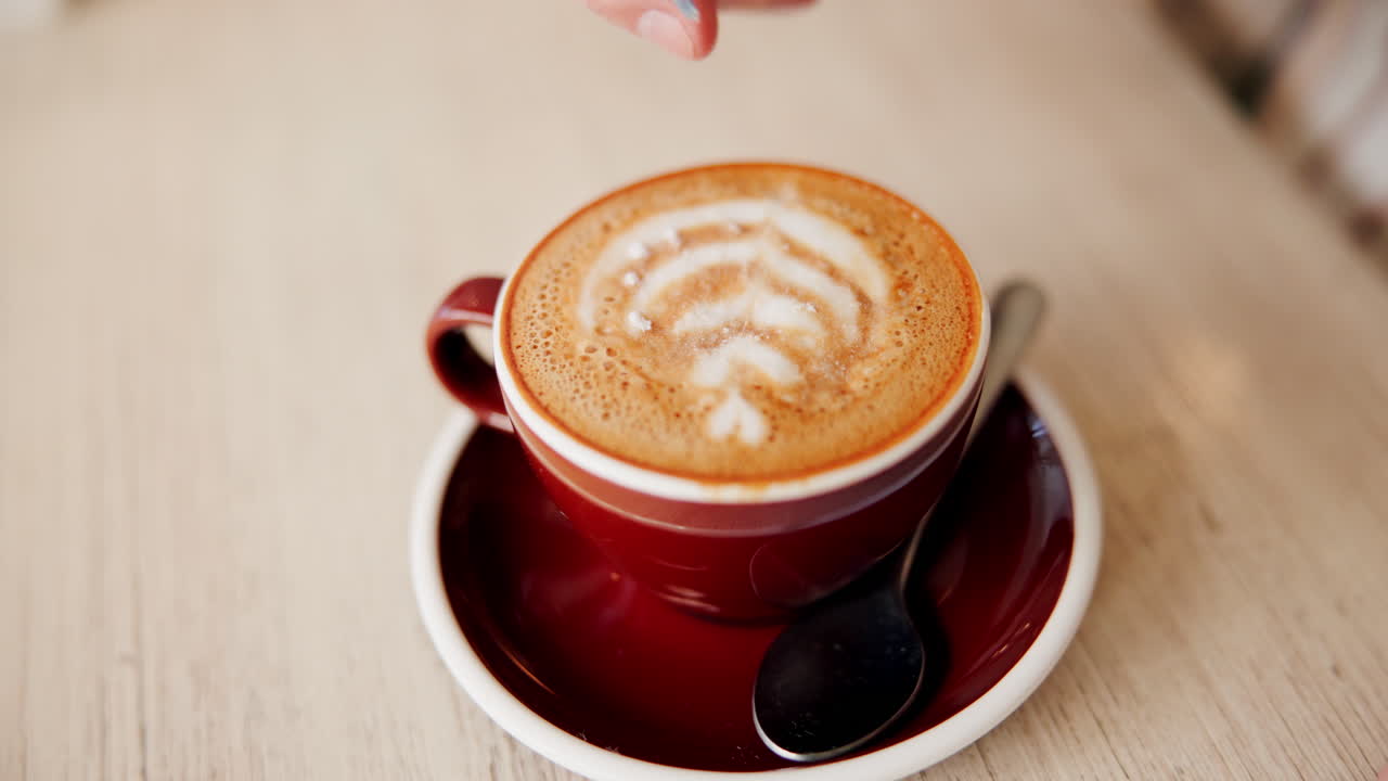 Adding sugar to a cappuccino