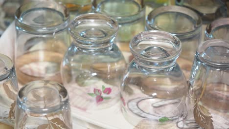 stacked empty drinking glasses on a decorative tray