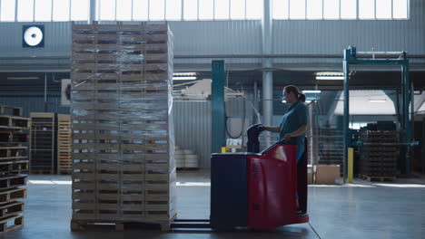 female driving warehouse truck moving package pallets operating transport