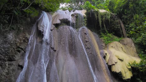 majestic waterfall cascading down a rocky cliff in a lush forest
