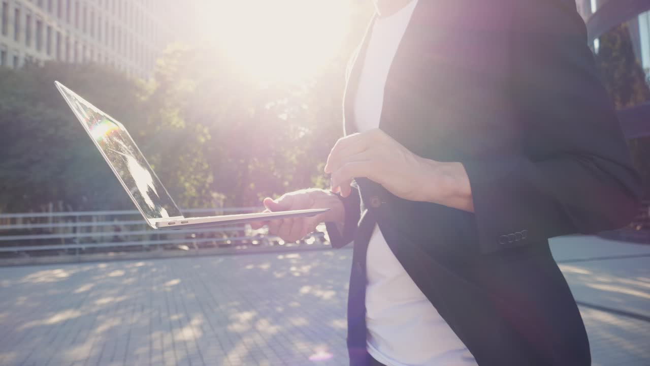 Business professional working on a laptop outdoors
