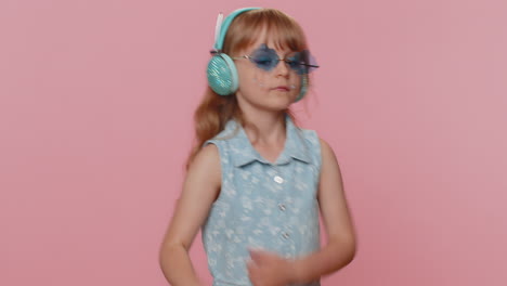 Happy-preteen-child-girl-kid-listening-music-via-headphones-and-dancing-disco-fooling-around
