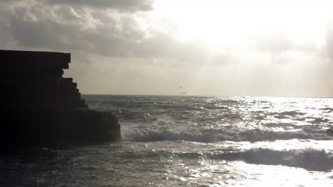 wavy sea and ancient walls of acre city israel