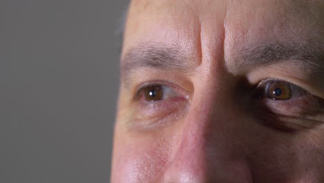 Close-Up-of-Man's-Eyes-Acknowledging-with-Hidden-Smile-Looking-into-a-Bright-Light