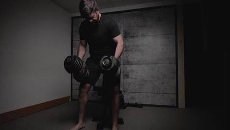 Dumbbell-seated-shoulder-press,-cinematic-lighting,-white-man-dressed-in-black-gym-attire