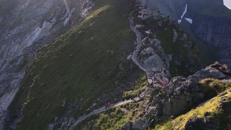 epic view of hiking tourists trekking up steep stairs on reinebringen ridge