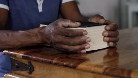 man-praying-to-God-with-hand-on-bible-with-people-stock-video-stock-footage