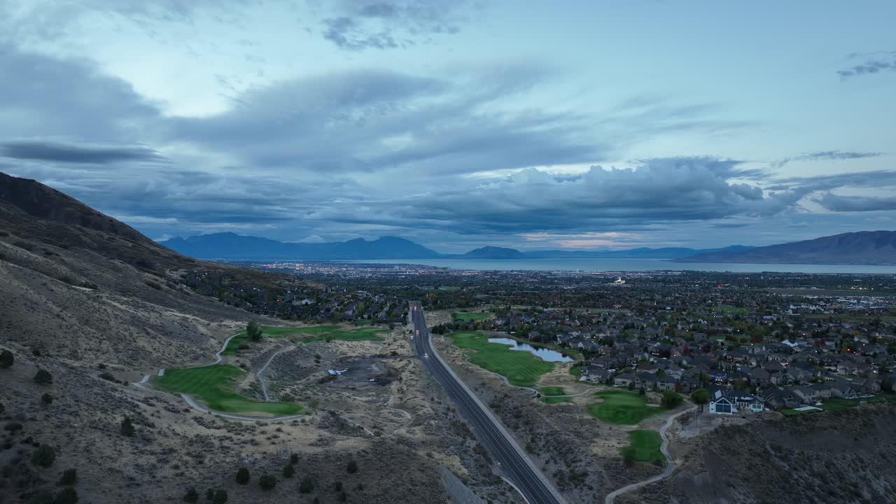 Cars Driving By Cedar Hills Golf Club in Highland On A Cloudy Morning In The Utah Valley, USA. Aerial Flyover