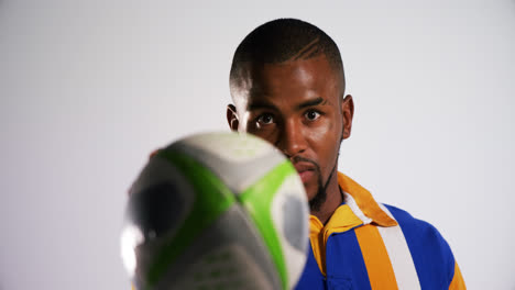 professional rugby sportsman showing a ball