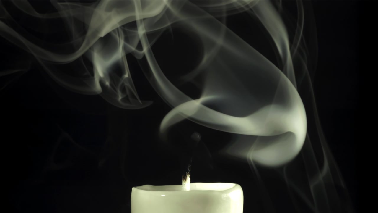 White Smoke Swirling from a Candle on a Black Background