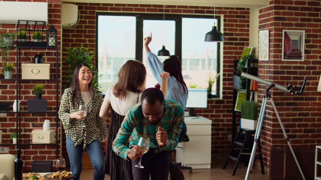 Friends jumping around house, busting dance moves to energetic music in cozy living room