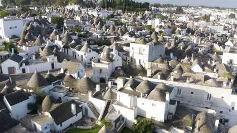 birds eye view of trulli di alberobello at sunrise in italy