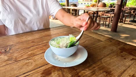 person making a green shaved ice dessert