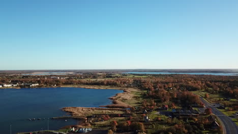 left-pan-shot-smokey-fireplace-and-wind-turbines-in-a-field-drone-descending