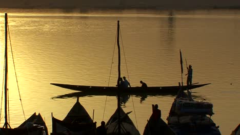 boats are rowed on the niger river in beautiful golden light in mali africa