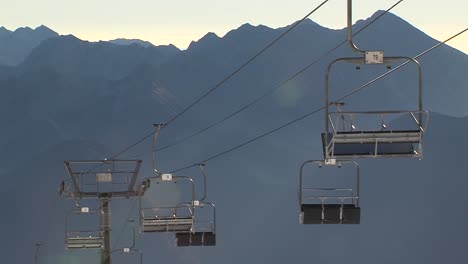 ski lifts at kanin stand still above rugged mountain peaks under a clear blue sky, static